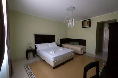 a bedroom with a white bed and a couch at Hotel Borgo di Ciàula in Santa Flavia