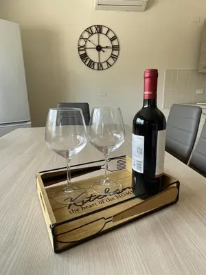 a bottle of wine and two wine glasses on a table at Il moro - Casa Vacanze in Terrasini