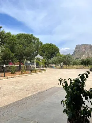 a empty street with a mountain in the background at Il moro - Casa Vacanze in Terrasini