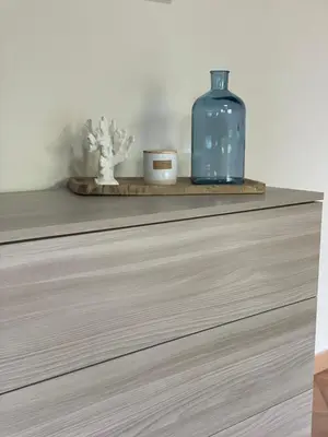 a shelf with a blue bottle and two candles at Il moro - Casa Vacanze in Terrasini
