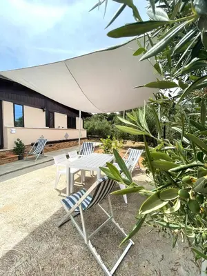 a group of chairs and a table and an umbrella at Il moro - Casa Vacanze in Terrasini