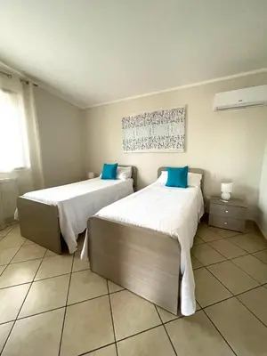 two beds sitting in a room with at Il moro - Casa Vacanze in Terrasini