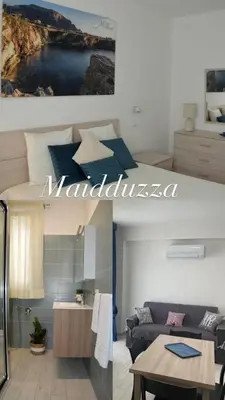 a living room with a couch and a table in a room at PESCA AZZURRA in Terrasini
