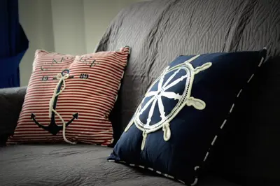 a couch with two pillows with a ship on it at PESCA AZZURRA in Terrasini