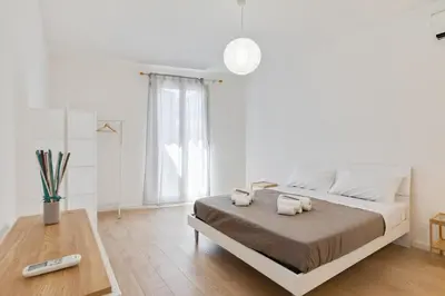 a bedroom with a bed with two towels on it at GuestHost - BallarHost - Ballarò Market Terrace Apartment in Palermo
