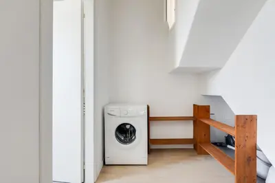 a washer and dryer in a white room at GuestHost - BallarHost - Ballarò Market Terrace Apartment in Palermo
