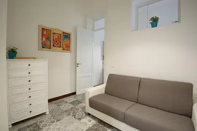 a living room with a couch and a dresser at HouseStation in Palermo
