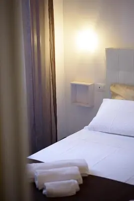a bedroom with a bed with two towels on it at HouseStation in Palermo