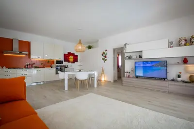 a kitchen and living room with a large screen tv at Golden Holiday Villas Private Pools in Sicily in Terrasini