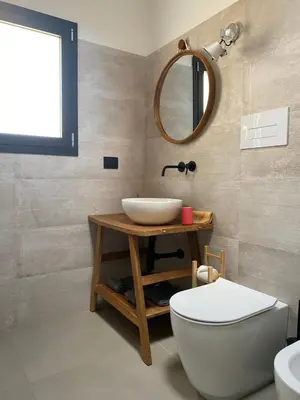 a bathroom with a sink and a toilet and a mirror at Le dimore di Palagonia in Bagheria