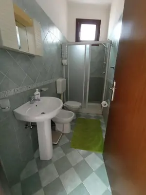 a bathroom with a sink and a toilet and a shower at Sandro Apartment in Castellammare del Golfo