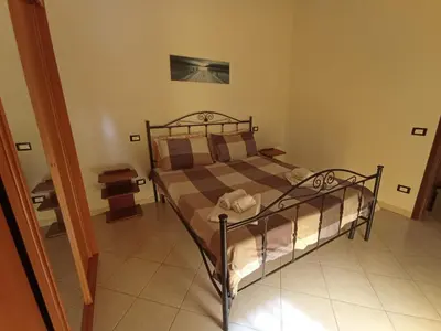 a bedroom with a bed in a room at Sandro Apartment in Castellammare del Golfo