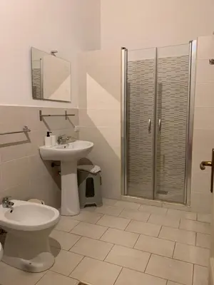 a bathroom with a toilet and a sink and a shower at 100 PASSI al Massimo in Palermo