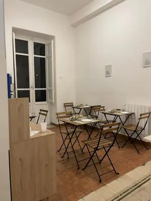 a dining room with a table and chairs in a room at 100 PASSI al Massimo in Palermo