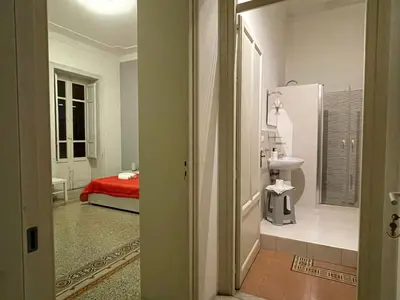 a bathroom with a red bed in a room at 100 PASSI al Massimo in Palermo