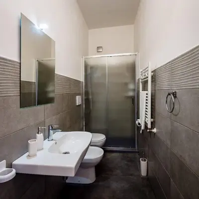 a bathroom with a sink and a toilet and a shower at Villa Michelangelo in Castellammare del Golfo
