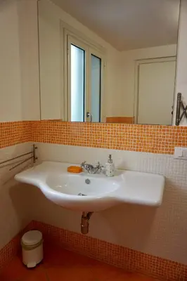 a bathroom with a white sink and a mirror at B&B Vivaldi in Palermo