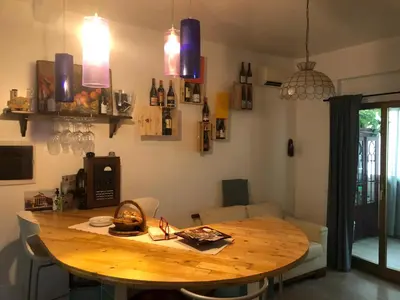 a wooden table in a room with a dining room at Casavacanze Tuttapposto in Palermo