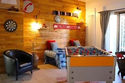 a living room with a foosball table and a couch at Casavacanze Tuttapposto in Palermo