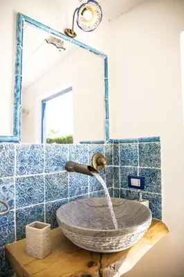 a sink in a bathroom with blue tiles at Dimora Fanale, Villa Esclusiva con Piscina Privata - Fanale Rentals in Altavilla Milicia