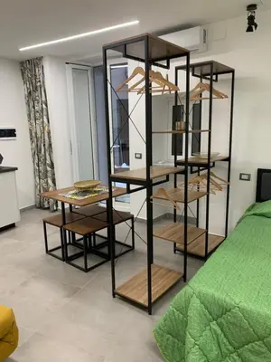a display case in a room with a bed at Kemonia Home Palermo in Palermo