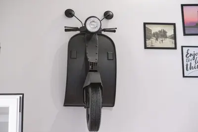 a scooter hanging on a wall with a clock at Loft Mercede al Capo in Palermo