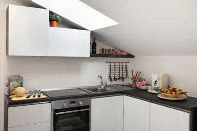 a kitchen with white cabinets and a sink at Appartamento Limone in Splendida villa Nature al mare di Scopello Zingaro in Scopello