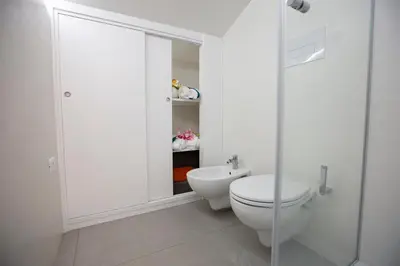 a white bathroom with a toilet and a shower at Appartamento Limone in Splendida villa Nature al mare di Scopello Zingaro in Scopello