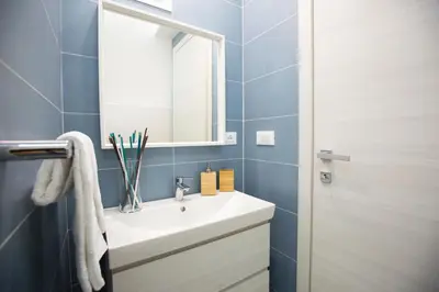 a bathroom with a white sink and a mirror at Appartamento Limone in Splendida villa Nature al mare di Scopello Zingaro in Scopello