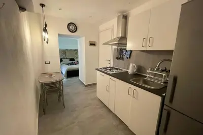a kitchen with a sink and a counter top at Tufoletto Apartment in Palermo