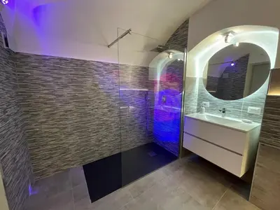 a bathroom with a sink and a mirror at Tufoletto Apartment in Palermo