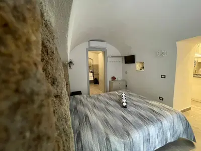 a bedroom with a large bed in a room at Tufoletto Apartment in Palermo