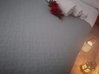 a table with a red rose on top of a white carpet at Historic Centre - Apartment Near Teatro Massimo in Palermo