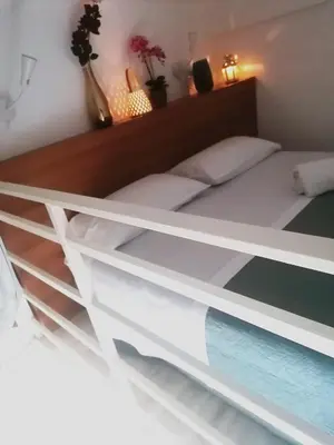 a bedroom with a bed with white shelves at Historic Centre - Apartment Near Teatro Massimo in Palermo