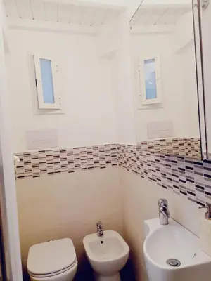 a bathroom with a toilet and a sink at Historic Centre - Apartment Near Teatro Massimo in Palermo