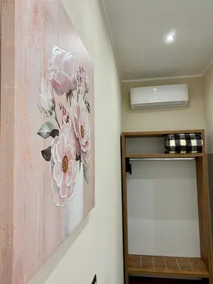 a painting of pink flowers on a wall at Arsenale Porto in Palermo