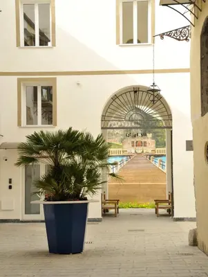 a potted plant sitting in front of a building at Arsenale Porto in Palermo