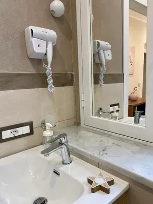 a bathroom with a sink and a mirror at Arsenale Porto in Palermo