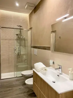 a bathroom with a sink and a toilet and a shower at Arsenale Porto in Palermo