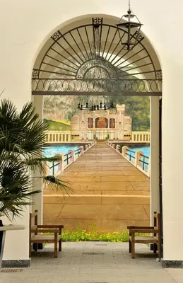 a painting of a pier with two benches at Arsenale Porto in Palermo