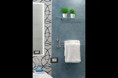 a bathroom with a mirror and a white towel at Alofara Apartment in San Vito lo Capo