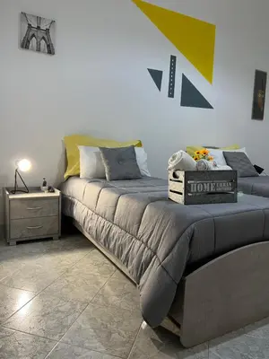 a bedroom with a large bed and a table at Gabry central apartment Palermo in Palermo