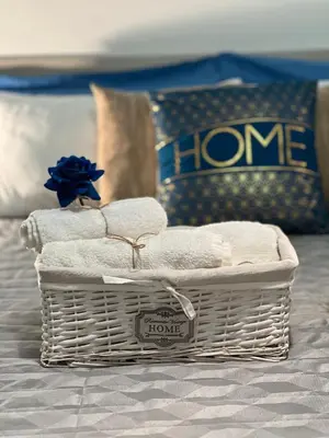 a basket of towels sitting on top of a bed at Gabry central apartment Palermo in Palermo