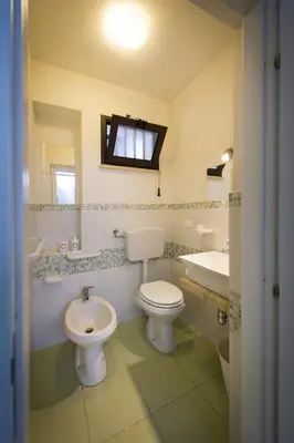 a bathroom with a toilet and a sink and a tub at La Perla del Golfo in Castellammare del Golfo