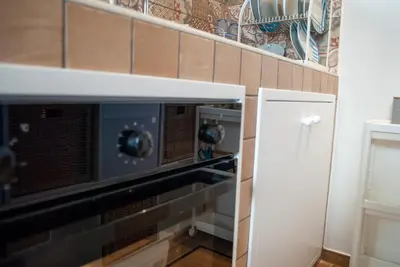 a kitchen with a microwave and a shelf at La casa di Nemi a San Vito in San Vito lo Capo