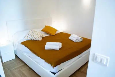 a bedroom with a bed with towels on it at La casa di Nemi a San Vito in San Vito lo Capo