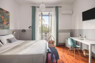 a bedroom with a bed and a couch at Dante Suites in Palermo