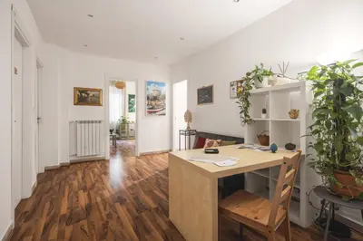 a living room with a wooden floor and white walls at Dante Suites in Palermo