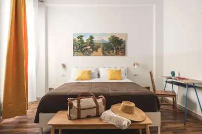 a bedroom with a bed with a hat on a table at Dante Suites in Palermo