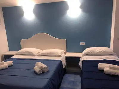 two beds in a room with towels on them at Le Camere della Campana in Castellammare del Golfo